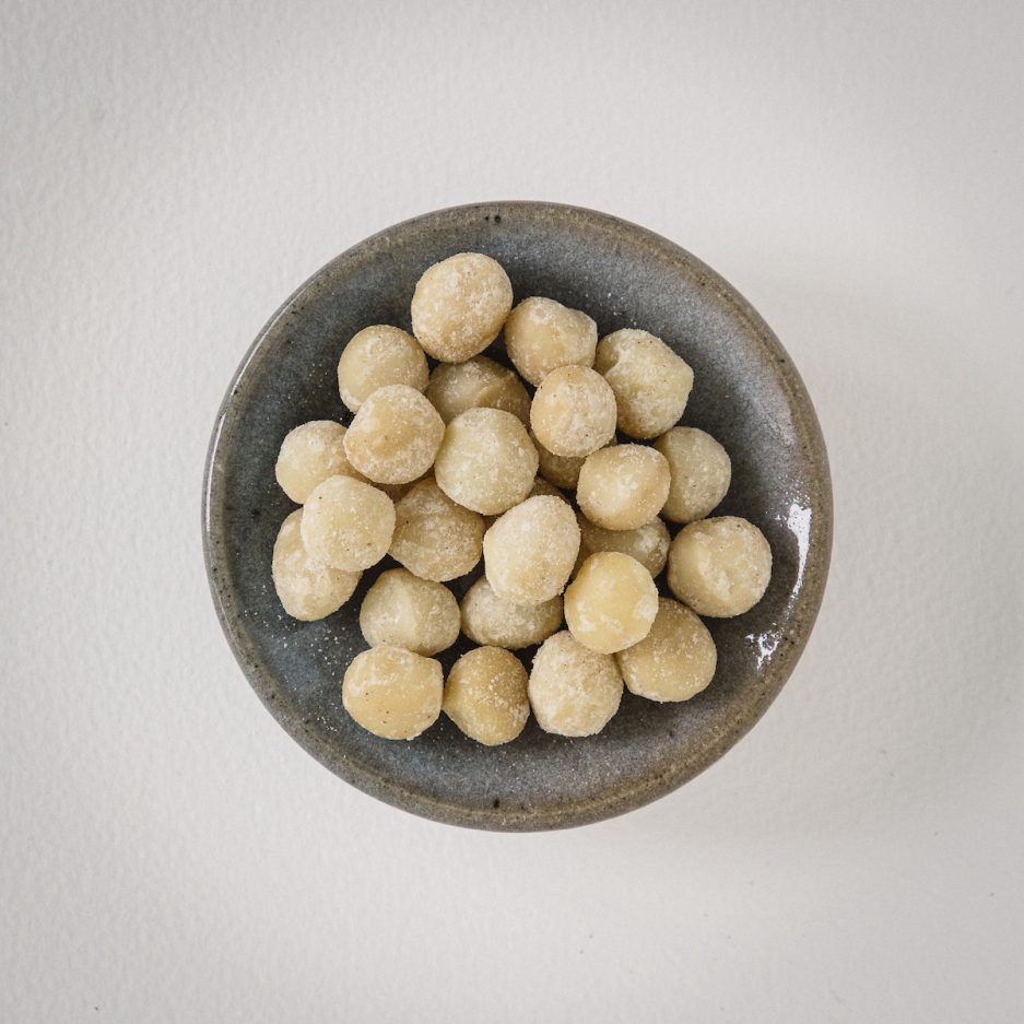 Macadamia nuts, which are rich, creamy, and buttery in flavor with a subtle hint of sweetness, are prized for their smooth, crunchy texture and are often used in a variety of culinary applications such as baking cookies, making nut butters, and adding a luxurious touch to both savory and sweet dishes, while also offering numerous health benefits including a high content of monounsaturated fats that support heart health, essential minerals like magnesium and manganese that aid in bone health, and antioxidants that can help combat oxidative stress and inflammation in the body. benefits, taste