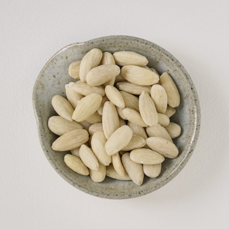 what are, Blanched almonds, which are almonds that have had their skins removed through a process of briefly boiling and then plunging them into cold water, resulting in a smooth, pale white nut with a slightly softer texture compared to unblanched almonds, are commonly used in various culinary applications such as making almond flour, adding to pastries and baked goods for a refined texture and mild flavor, or incorporating into sauces and soups to create a creamy consistency, while also being valued for their versatility in recipes that require a delicate nut flavor without the slightly bitter taste of the almond skin.